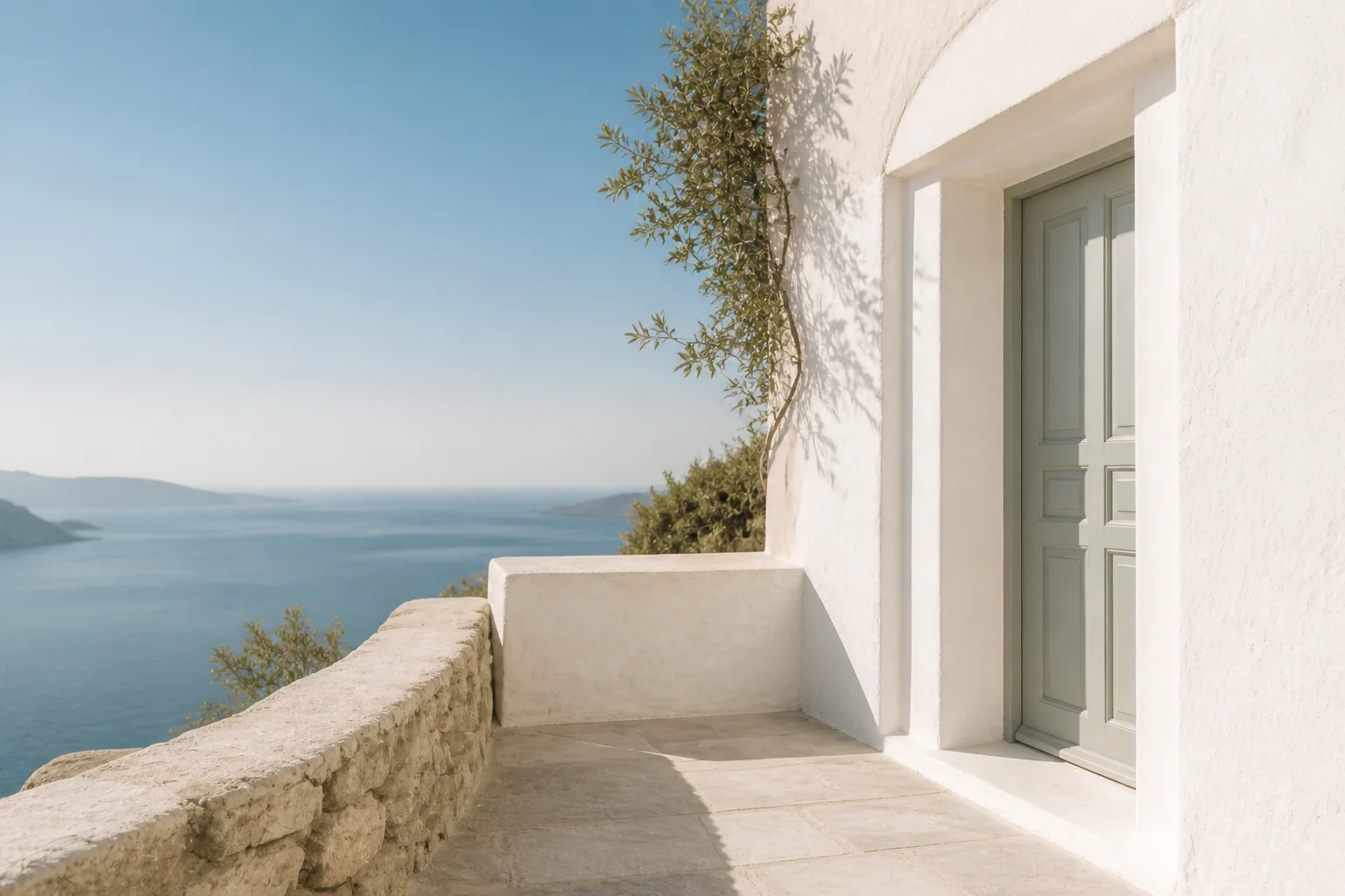 White Cycladic terrace looking across the Aegean Sea