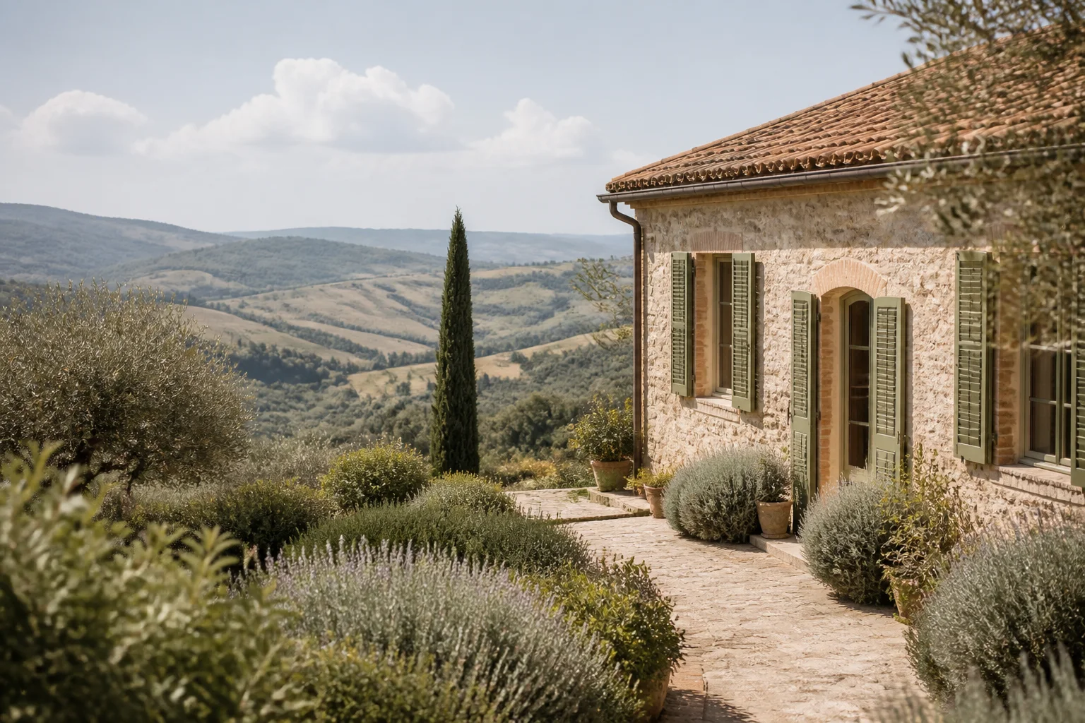 Warm stone Tuscan home among olive trees and soft hills
