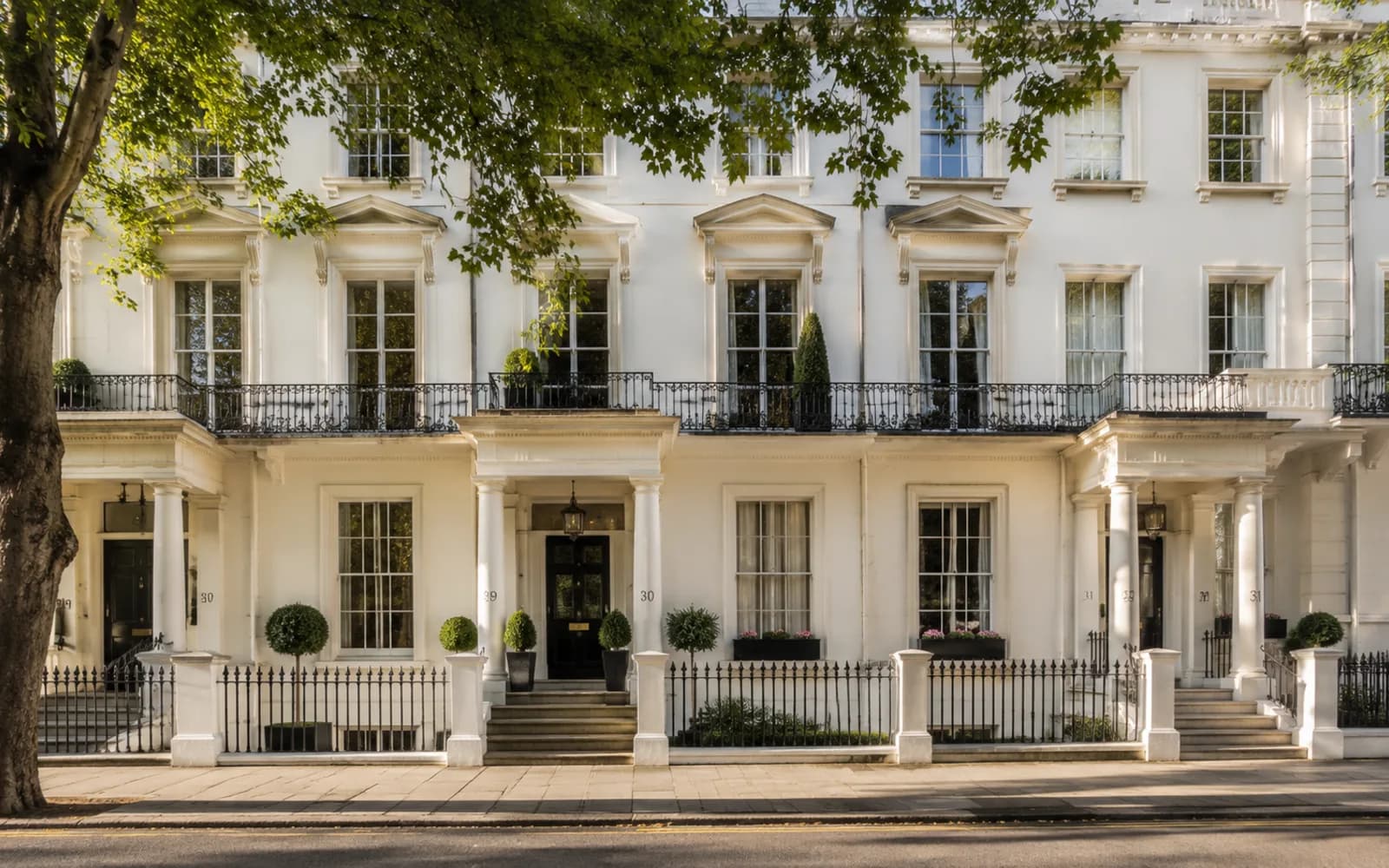 Traditional London townhouses on a tree-lined street
